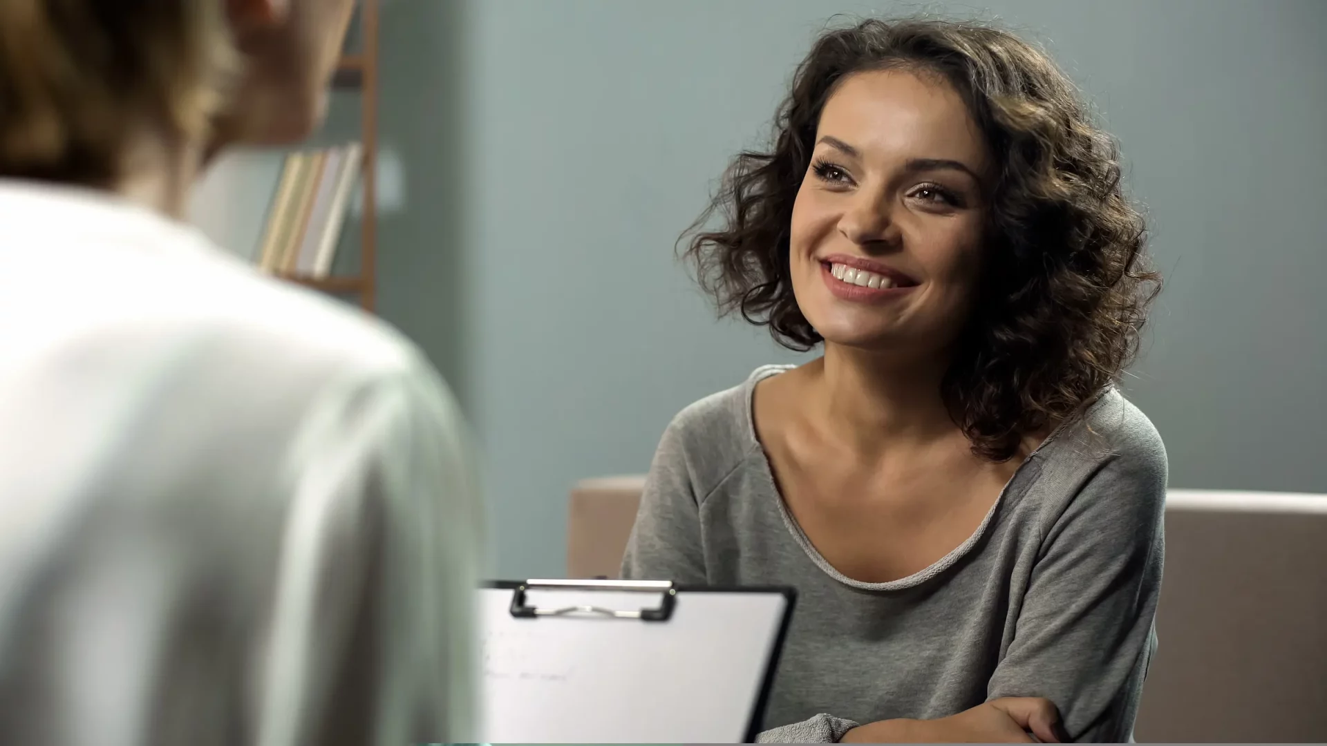 woman smiling, talking to doctor