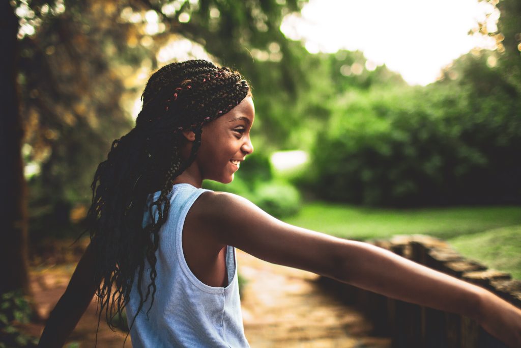 smiling young black girl in park