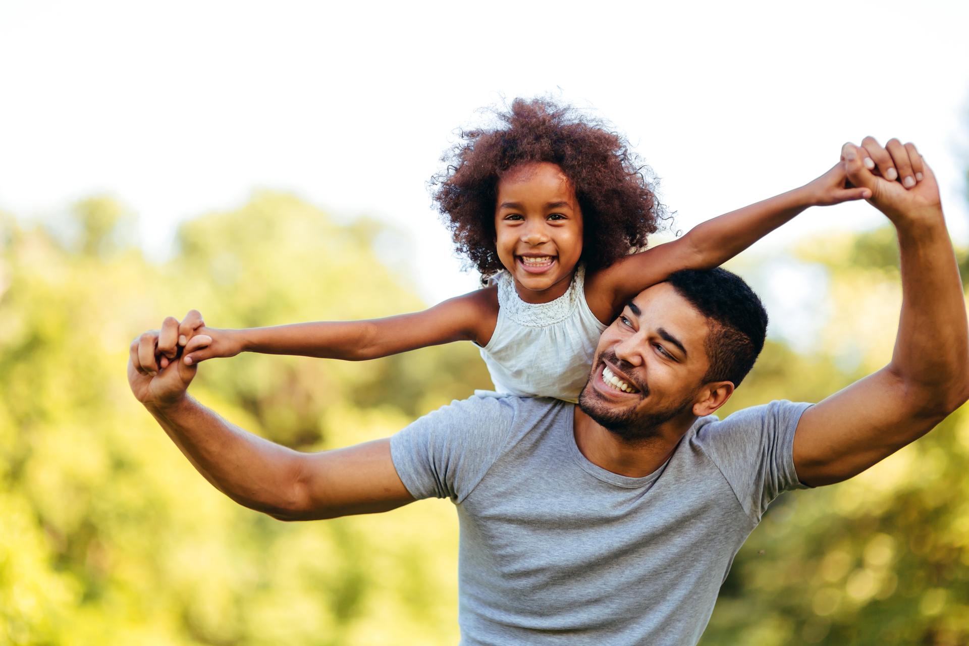 happy daughter and father playing outside