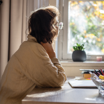 woman staring out of a window.